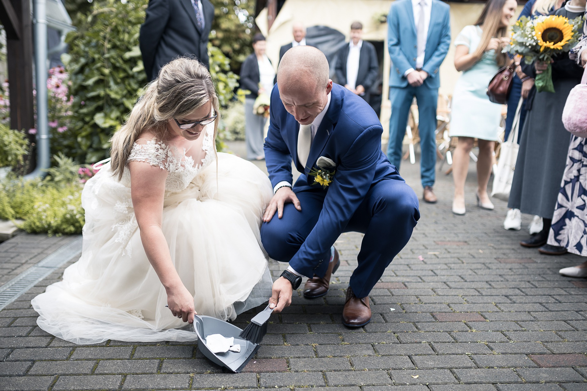 Svatební fotograf Kladno - ženich a nevěsta zametají rozbitý talíř